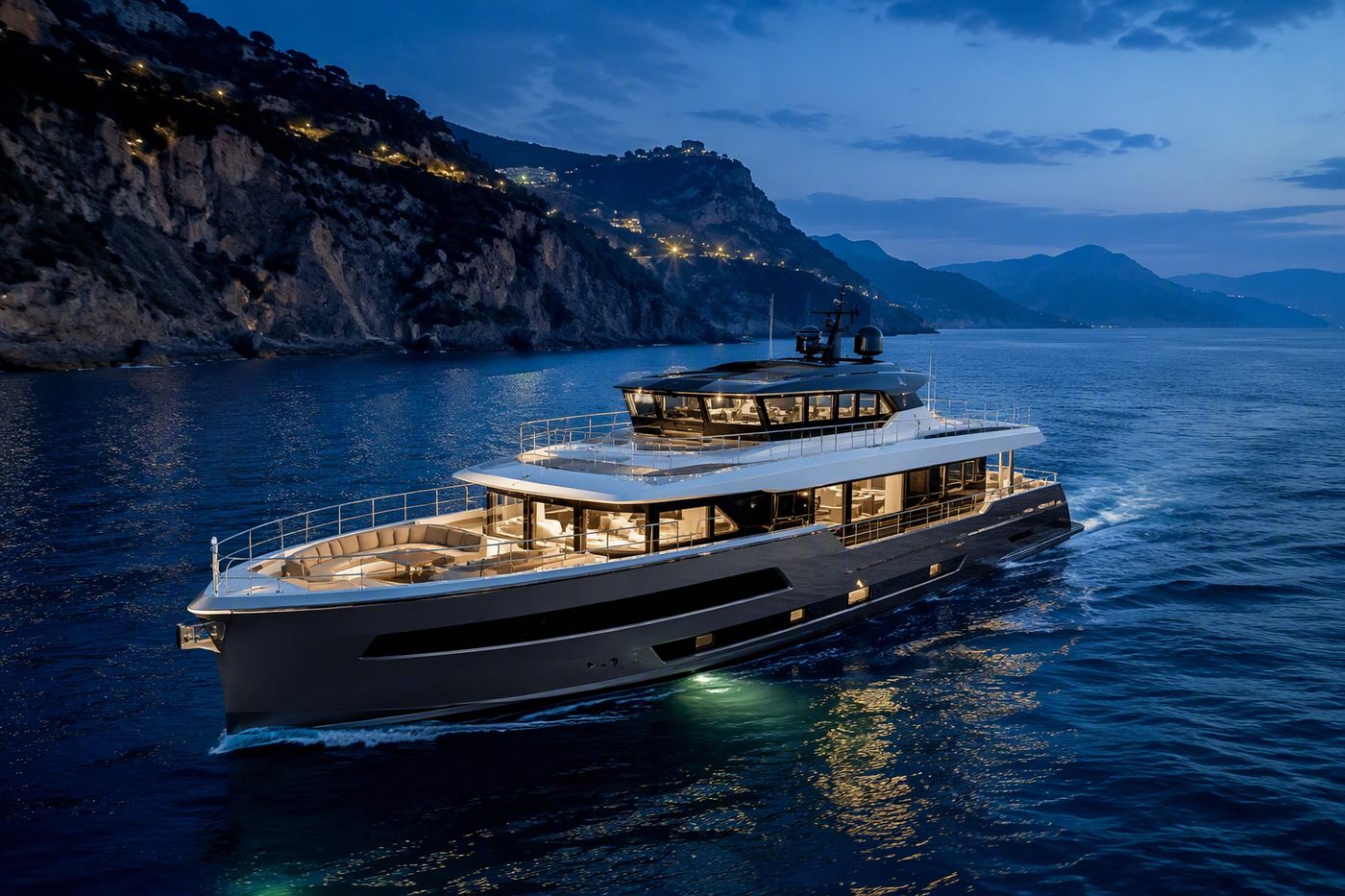 Voyager Sky — premium long-range cruiser with enclosed sky lounge cruising a dramatic coastline at blue hour